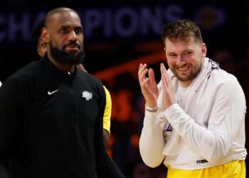 LOS ANGELES, CALIFORNIA - FEBRUARY 10: LeBron James #23 and Luka Doncic #77 of the Los Angeles Lakers react at the end of  the fourth quarter of a game against the Utah Jazz at Crypto.com Arena on February 10, 2025 in Los Angeles, California. The Los Angeles Lakers beat the Utah Jazz 132-113. NOTE TO USER: User expressly acknowledges and agrees that, by downloading and or using this photograph, User is consenting to the terms and conditions of the Getty Images License Agreement. (Photo by Ronald Martinez/Getty Images)