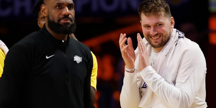 LOS ANGELES, CALIFORNIA - FEBRUARY 10: LeBron James #23 and Luka Doncic #77 of the Los Angeles Lakers react at the end of  the fourth quarter of a game against the Utah Jazz at Crypto.com Arena on February 10, 2025 in Los Angeles, California. The Los Angeles Lakers beat the Utah Jazz 132-113. NOTE TO USER: User expressly acknowledges and agrees that, by downloading and or using this photograph, User is consenting to the terms and conditions of the Getty Images License Agreement. (Photo by Ronald Martinez/Getty Images)