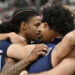 Ja Morant, Jaylen Wells and their Grizzlies teammates huddled in prayer after a fan collapsed in the stands. (AP Photo/Brandon Dill)