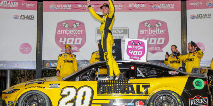 HAMPTON, GEORGIA - FEBRUARY 23: Christopher Bell, driver of the #20 DEWALT Toyota, celebrates in victory lane after winning the NASCAR Cup Series Ambetter Health 400 at Atlanta Motor Speedway on February 23, 2025 in Hampton, Georgia. (Photo by Jonathan Bachman/Getty Images)