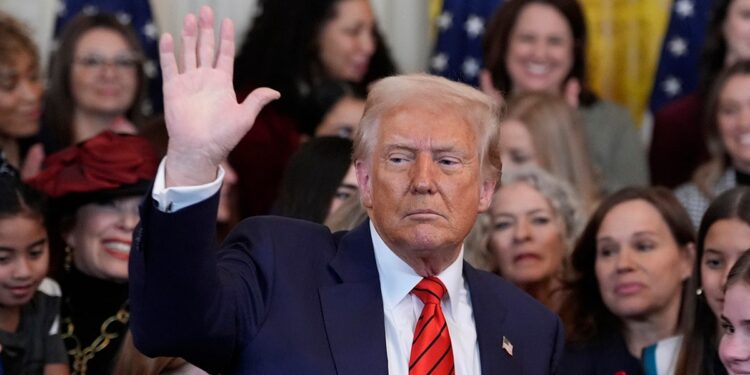 Trump waves after executive order