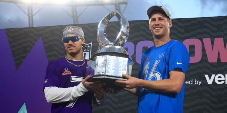 ORLANDO, FLORIDA - FEBRUARY 02: Defensive MVP Byron Murphy Jr. #7 of the Minnesota Vikings and offensive MVP Jared Goff #16 of the Detroit Lions hold the Pro Bowl Games trophy after defeating the and AFC 76-63 in the NFL Pro Bowl Games at Camping World Stadium on February 02, 2025 in Orlando, Florida. (Photo by Mike Ehrmann/Getty Images)