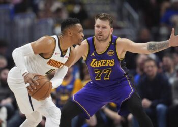 Denver Nuggets guard Russell Westbrook, left, looks to pass the ball as Los Angeles Lakers.