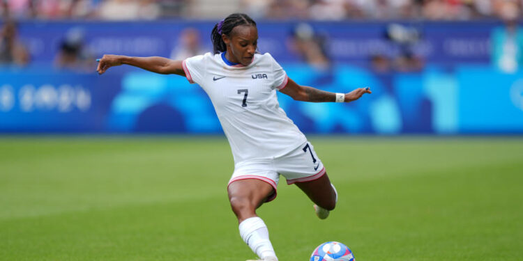 PARIS, FRANCE - AUGUST 03: Crystal Dunn #7 of the United States strikes the ball during the first half against Japan during the Women's Quarterfinal match during the Olympic Games Paris 2024 at Parc des Princes on August 03, 2024 in Paris, France. (Photo by Andrea Vilchez/ISI/Getty Images)