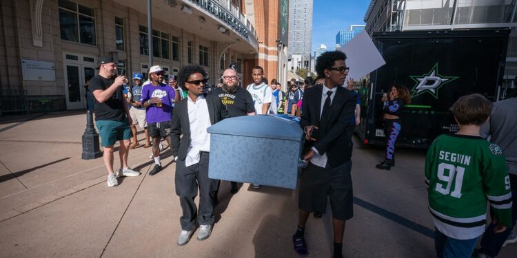 Mavericks fans carry coffin outside arena