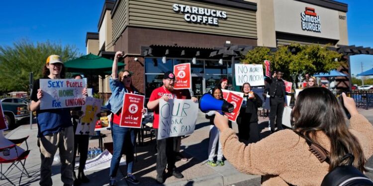 Starbucks employees strike outside their store, in Mesa, Arizona in US.