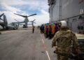 A pair of MV-22 Osprey transport aircraft are parked aboard the U.S. Navy amphibious assault ship USS Iwo Jima in the Cari...