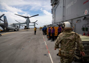 A pair of MV-22 Osprey transport aircraft are parked aboard the U.S. Navy amphibious assault ship USS Iwo Jima in the Cari...