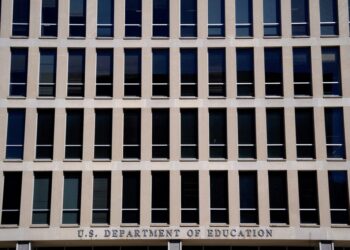 FILE PHOTO: Demonstrators rally in support of U.S.Department of Education outside its building in Washington