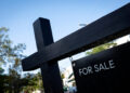 FILE PHOTO: A "For Sale" sign stands at a house in Miami