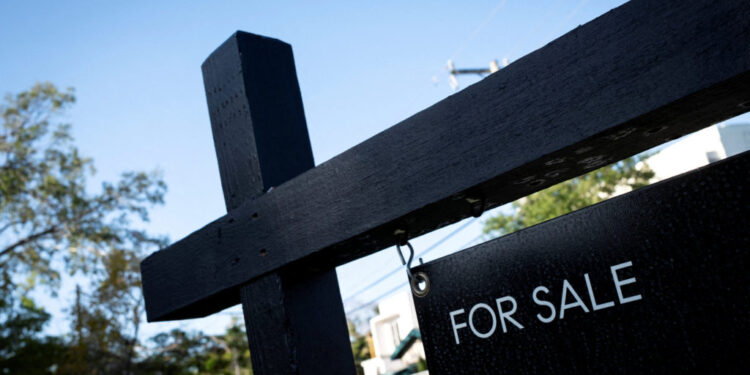 FILE PHOTO: A "For Sale" sign stands at a house in Miami