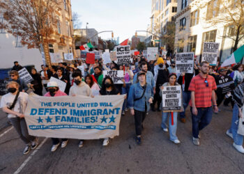 People protest as federal immigration authorities conduct raids in North Carolina