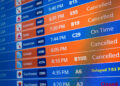 Flight timings and cancellations are displayed on a departures board