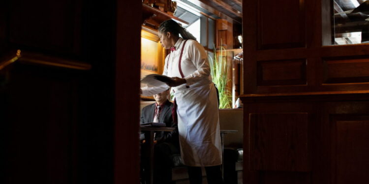 Waitress Mattie Wright serves guests at the Old Ebbitt Grill in Washington