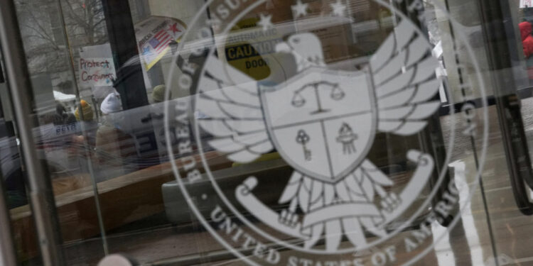 FILE PHOTO: Protest the day after members of Elon Musk's Department of Government Efficiency moved into the CFPB, in Washi...