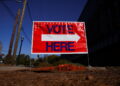 A sign sits outside of a polling location as the battleground state opened for early voting, in Atlanta
