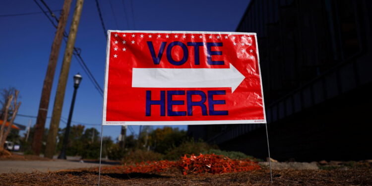 A sign sits outside of a polling location as the battleground state opened for early voting, in Atlanta