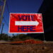 A sign sits outside of a polling location as the battleground state opened for early voting, in Atlanta
