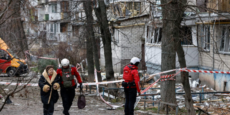 FILE PHOTO: Emergency responders work at the site of a Russian drone strike on an apartment building, in Kyiv