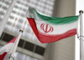 Iranian flag flies in front of the UN office building in Vienna