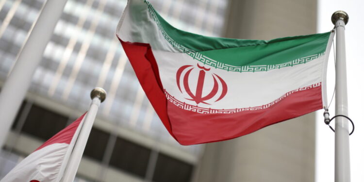 Iranian flag flies in front of the UN office building in Vienna