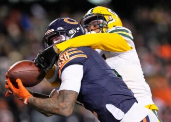 Chicago Bears wide receiver DJ Moore catches a 46-yard touchdown pass as the Green Bay Packers' Keisean Nixon defends to give the Bears a 22-16 overtime win on Saturday night in Chicago. (AP Photo/Nam Huh)