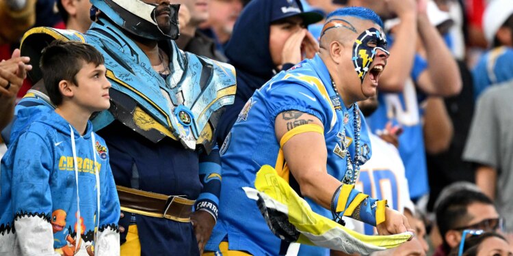Charger fans cheer during the second half at SoFi Stadium...
