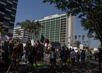 Community members take part in the Dena Protest that started a Pasadena City Hall and walked by four hotels, the Dena Hotel Pasadena, Hilton Pasadena, AC Hotel Pasadena, Westin Hotel Pasadena, in the area that housed ICE officials