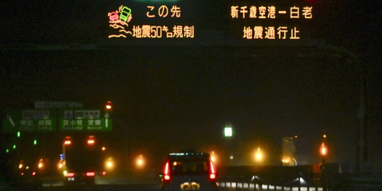 A sign displays road closure information due to an earthquake on a highway in Chitose