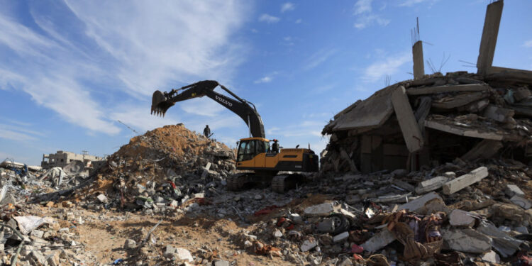 Heavy machinery operates at a site as as Hamas says it continues to search for the bodies of deceased hostages, in Beit La...