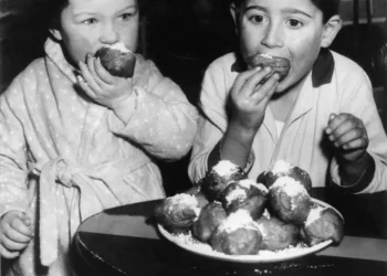 Two Dutch Children Eat Doughnut In 1959