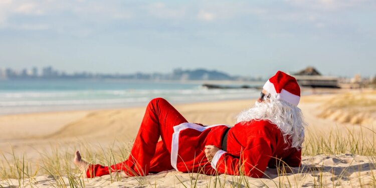 Summer Santa lying on the beach