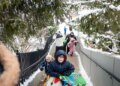 Sledders head to the top of the hill at Barrie Park on Nov. 30, 2025, in Oak Park after the region recorded over 8 inches of snow. (Brian Cassella/Chicago Tribune)