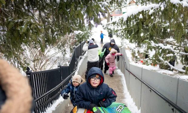 Sledders head to the top of the hill at Barrie Park on Nov. 30, 2025, in Oak Park after the region recorded over 8 inches of snow. (Brian Cassella/Chicago Tribune)