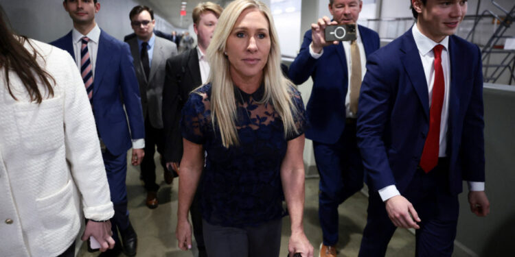 U.S. Representative Marjorie Taylor Greene (R-GA) walks to her final vote, surrounded by staff, in Washington