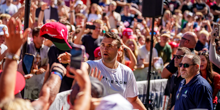 Charlie Kirk surrounded by a large audience, tosses hats to the crowd shortly before his assassination in Utah
