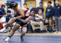 Dulaneyâs Roger Sacks pulls Biehmo Chai to the mat during...