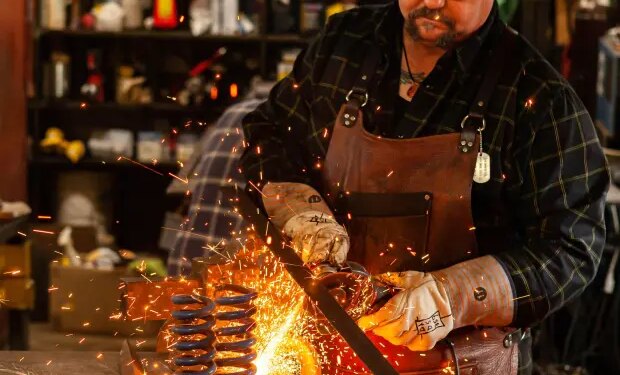 Steve Kost, of Palos Park, works on "Heavy Hearts," a sculpture made from metal and found objects. The former Navy Seabee was among artists showing work at the first display of art by veterans last year at McCord Gallery & Cultural Center in Palos Park. (Daniel Cherry)