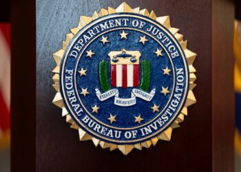 FILE - An FBI seal is displayed on a podium before a news conference at the field office in Portland, Ore., Jan. 16, 2025. (AP Photo/Jenny Kane, File)