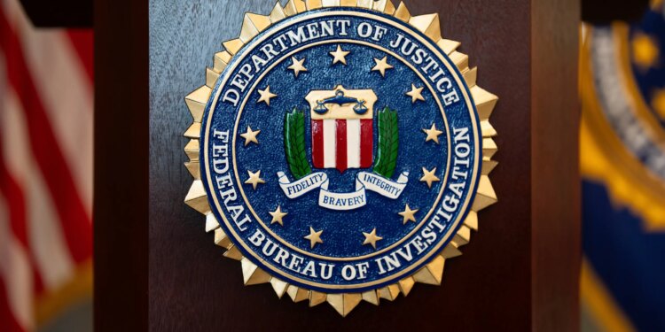 FILE - An FBI seal is displayed on a podium before a news conference at the field office in Portland, Ore., Jan. 16, 2025. (AP Photo/Jenny Kane, File)