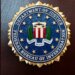 FILE - An FBI seal is displayed on a podium before a news conference at the field office in Portland, Ore., Jan. 16, 2025. (AP Photo/Jenny Kane, File)