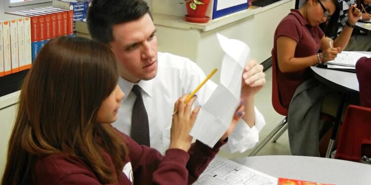 State Rep. and U.S. Senate candidate James Talarico works with a student at Jeremiah Rhodes Middle School in San Antonio, where he taught between 2011-13.