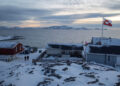 A Greenland flag flies as people walk on the day of a meeting between top U.S. officials and the foreign ministers of Denm...