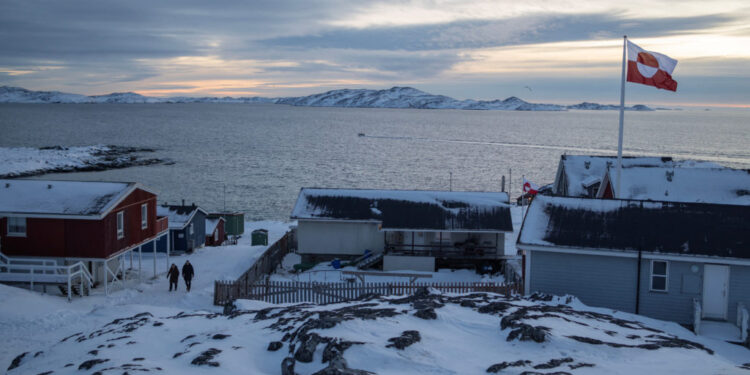 A Greenland flag flies as people walk on the day of a meeting between top U.S. officials and the foreign ministers of Denm...