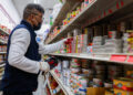 A Sun Vin Grocery employee adds price tags and stocks shelves in Chinatown in New York