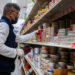 A Sun Vin Grocery employee adds price tags and stocks shelves in Chinatown in New York