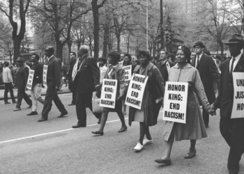 Marchers wear signs that read 'Honor King: End Racism!' and 'Union Justice Now' as they participate in the Sanitation Workers march, soon after the assassination of Dr. Martin Luther King, Jr., Memphis, Tenn., April 1968.