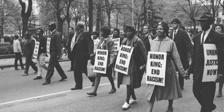 Marchers wear signs that read 'Honor King: End Racism!' and 'Union Justice Now' as they participate in the Sanitation Workers march, soon after the assassination of Dr. Martin Luther King, Jr., Memphis, Tenn., April 1968.