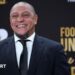 Roberto Carlos smiles for a photo while wearing a suit at the Fifa World Cup draw