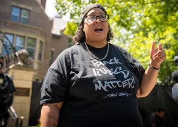 BLM leader in black shirt at outside rally